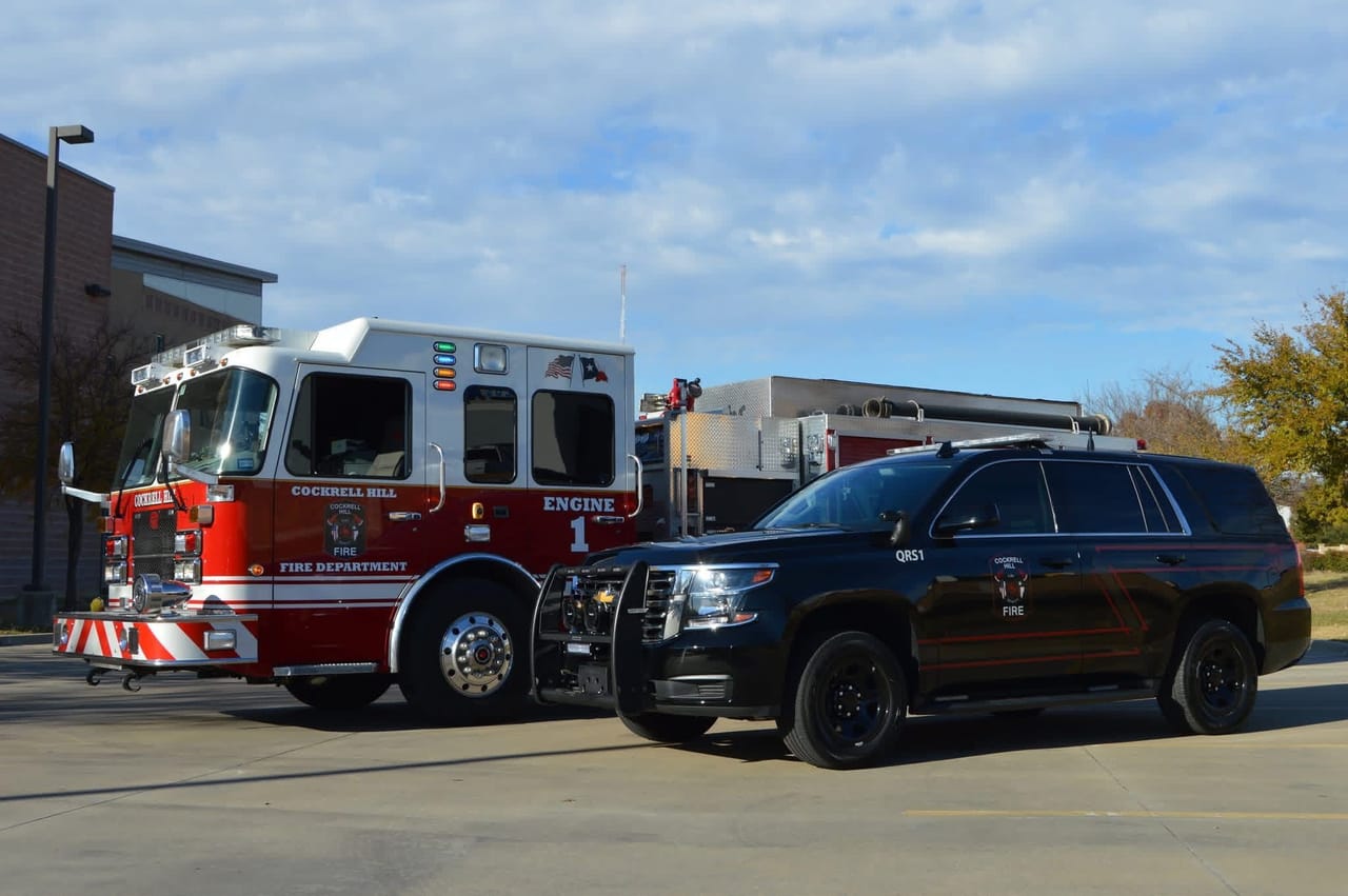 Engine 1 parked beside a black Cockrell Hill Fire Department command SUV